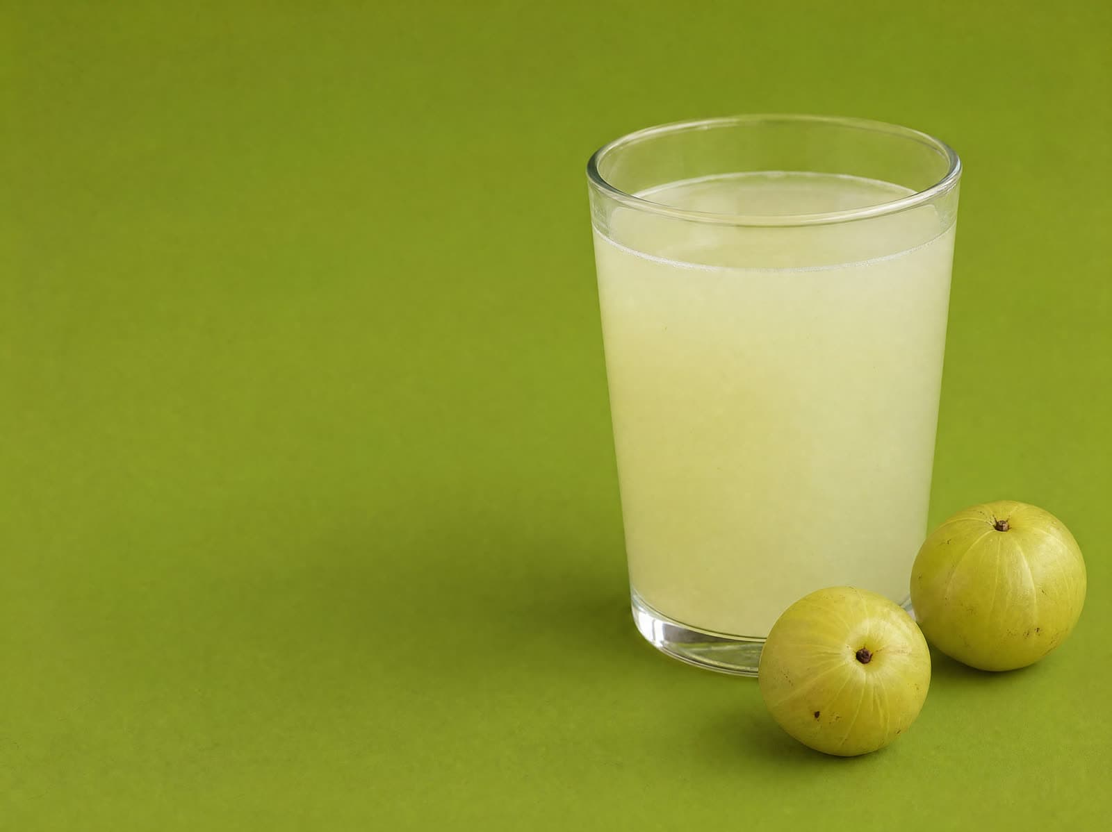 Amla Powder stirred into a glass of warm water