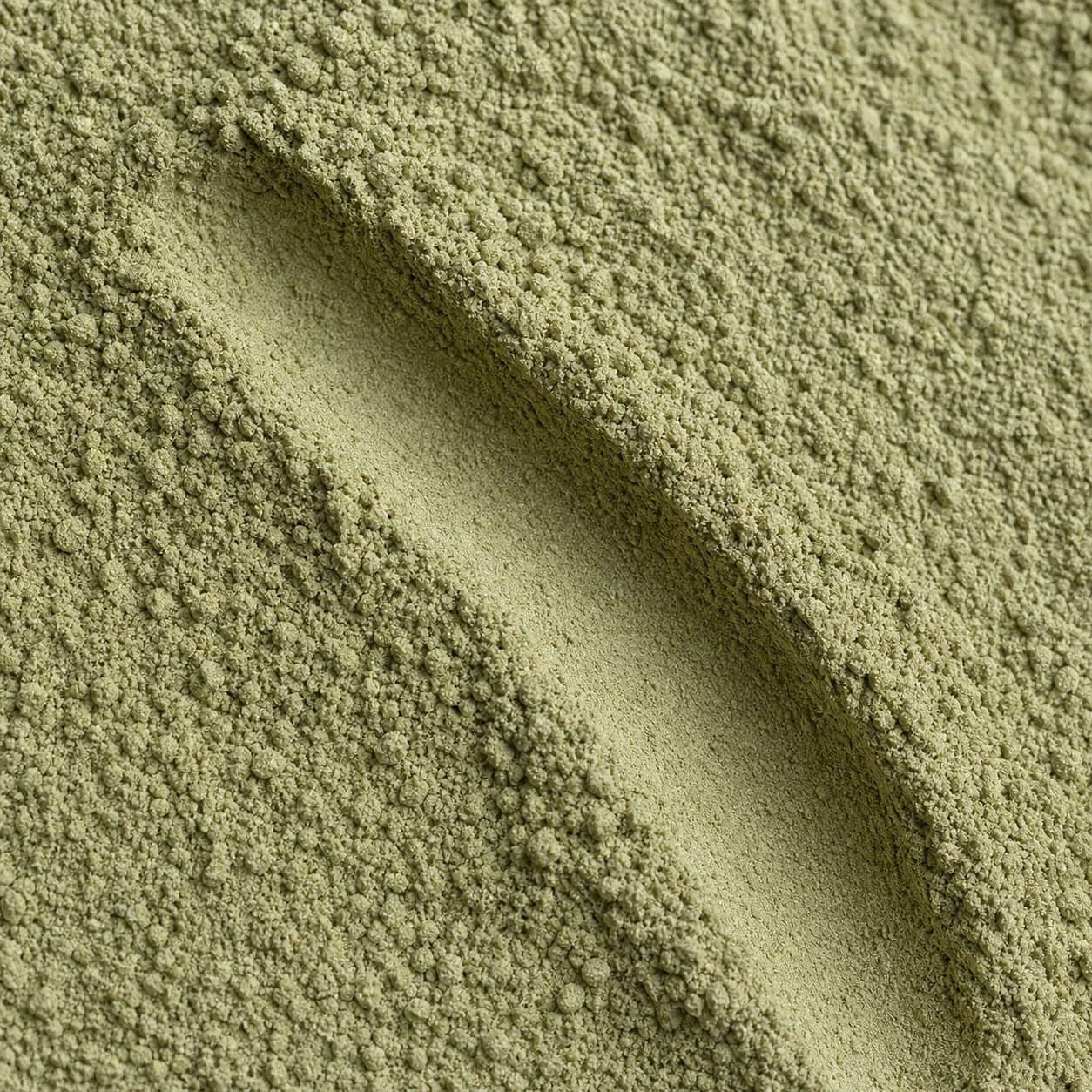A close-up of fine green-grey Amla Powder