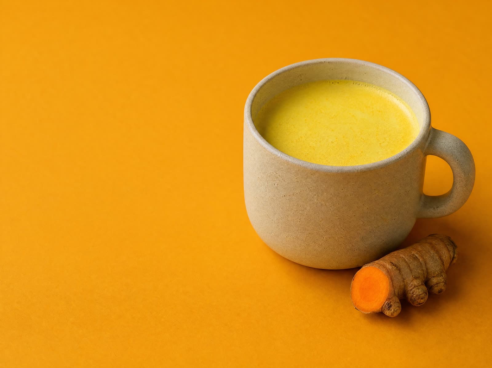 Turmeric Powder whisked into a mug of golden milk