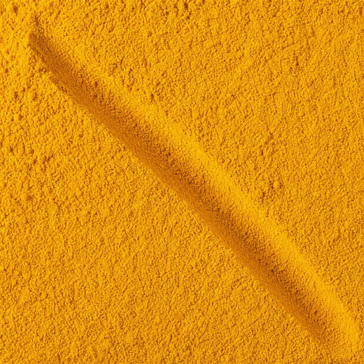 A close-up of bright yellow Turmeric Powder