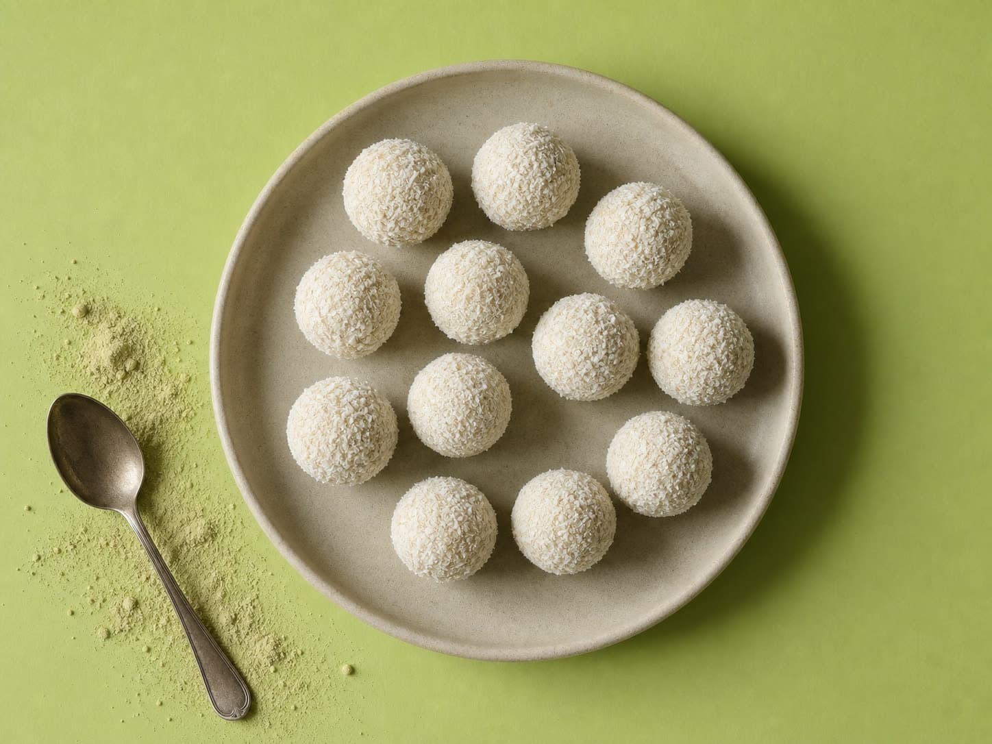 A plate of Amla-Honey Energy Balls rolled in coconut